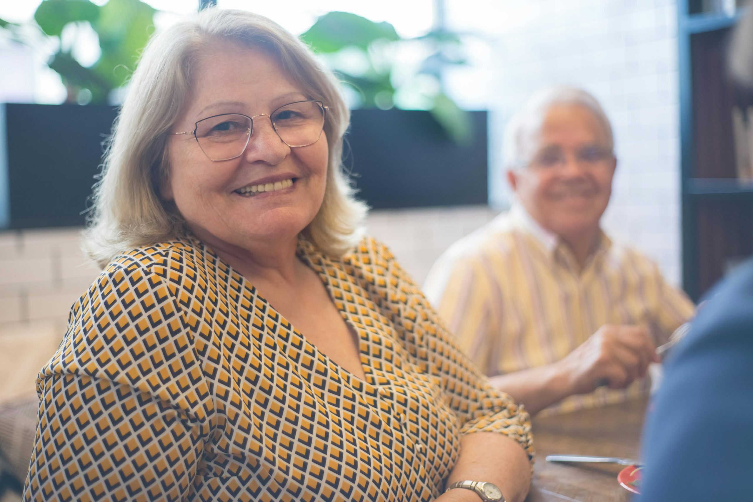 a couple of seniors, sitting and smiling at the camera